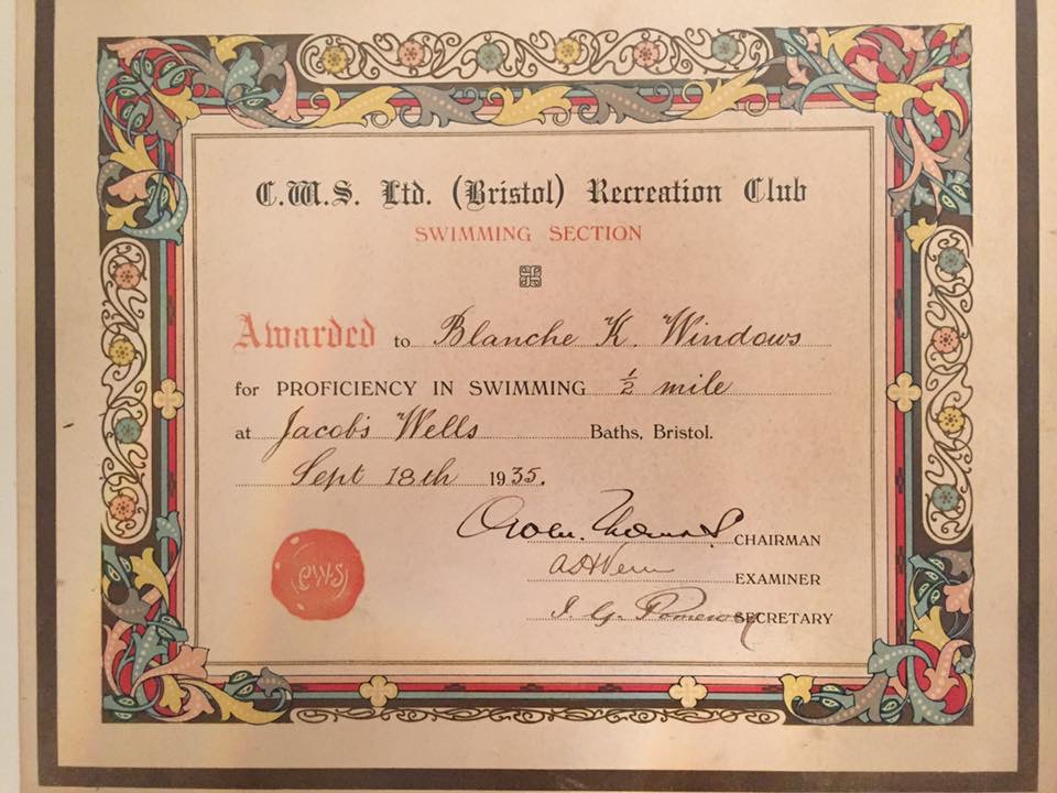 Certificate with colourful border from “C.W.S. Ltd. (Bristol) Recreation Club Swimming Section” “Awarded to Blanche K Windows for proficiency in swimming 1/2mile at Jacob’s Wells Baths, Bristol. Sept 18th 1935.