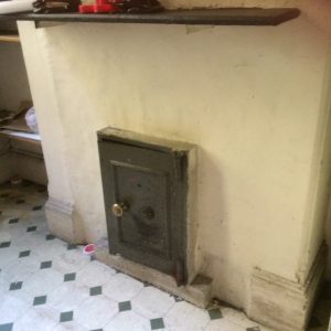 Metal safe embedded into a chimney breast, where a fireplace may once have been