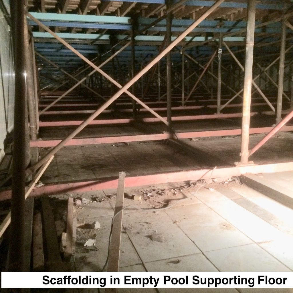 Photo of scaffolding resting on the tiled pool floor